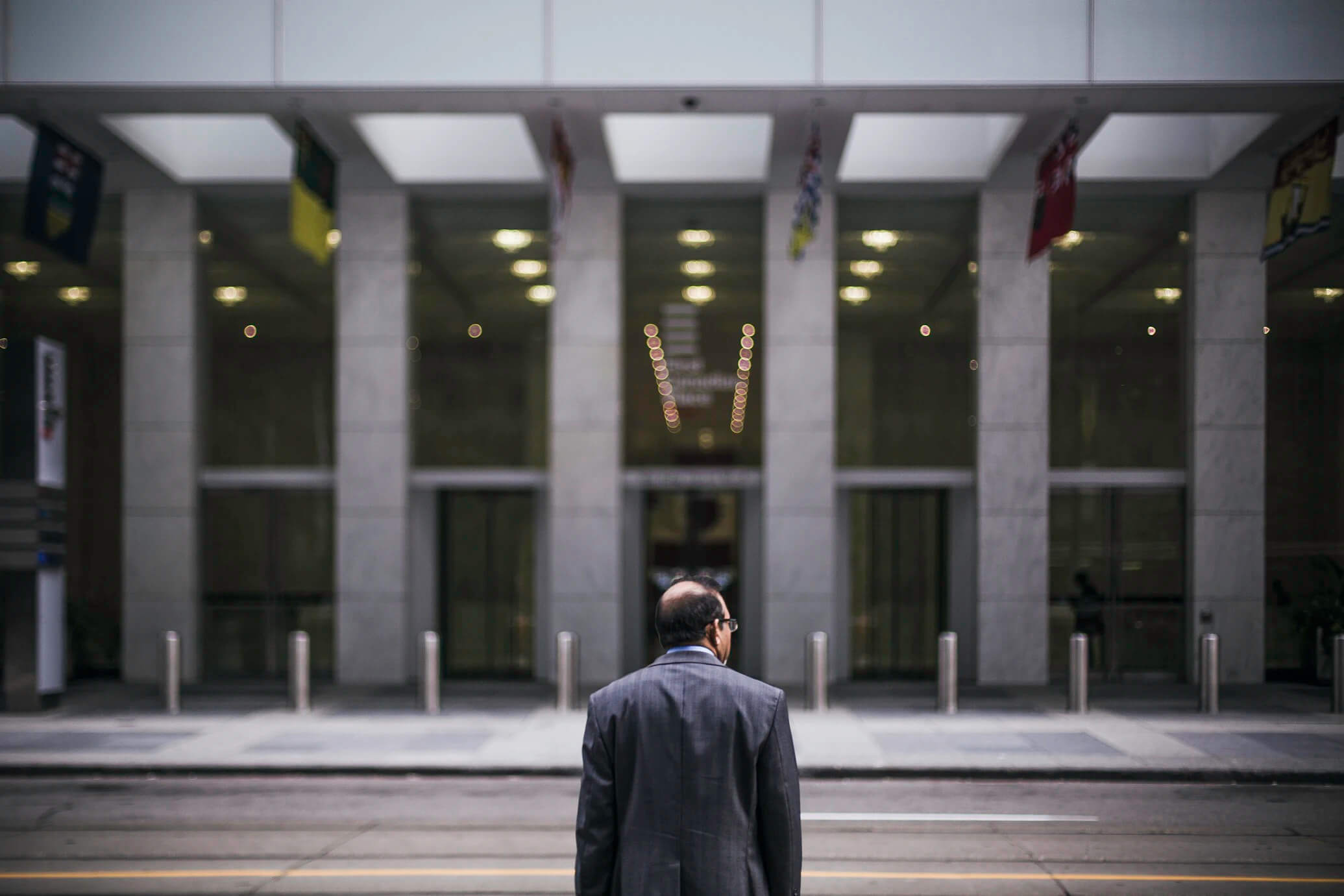 man standing in front of corporate building