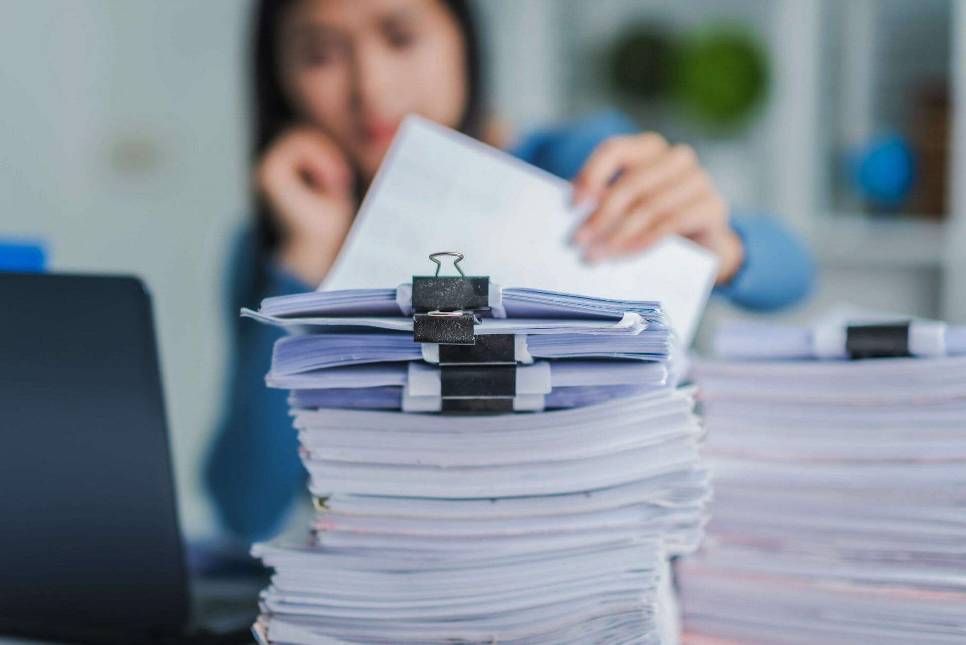 image of woman and a pile of documents